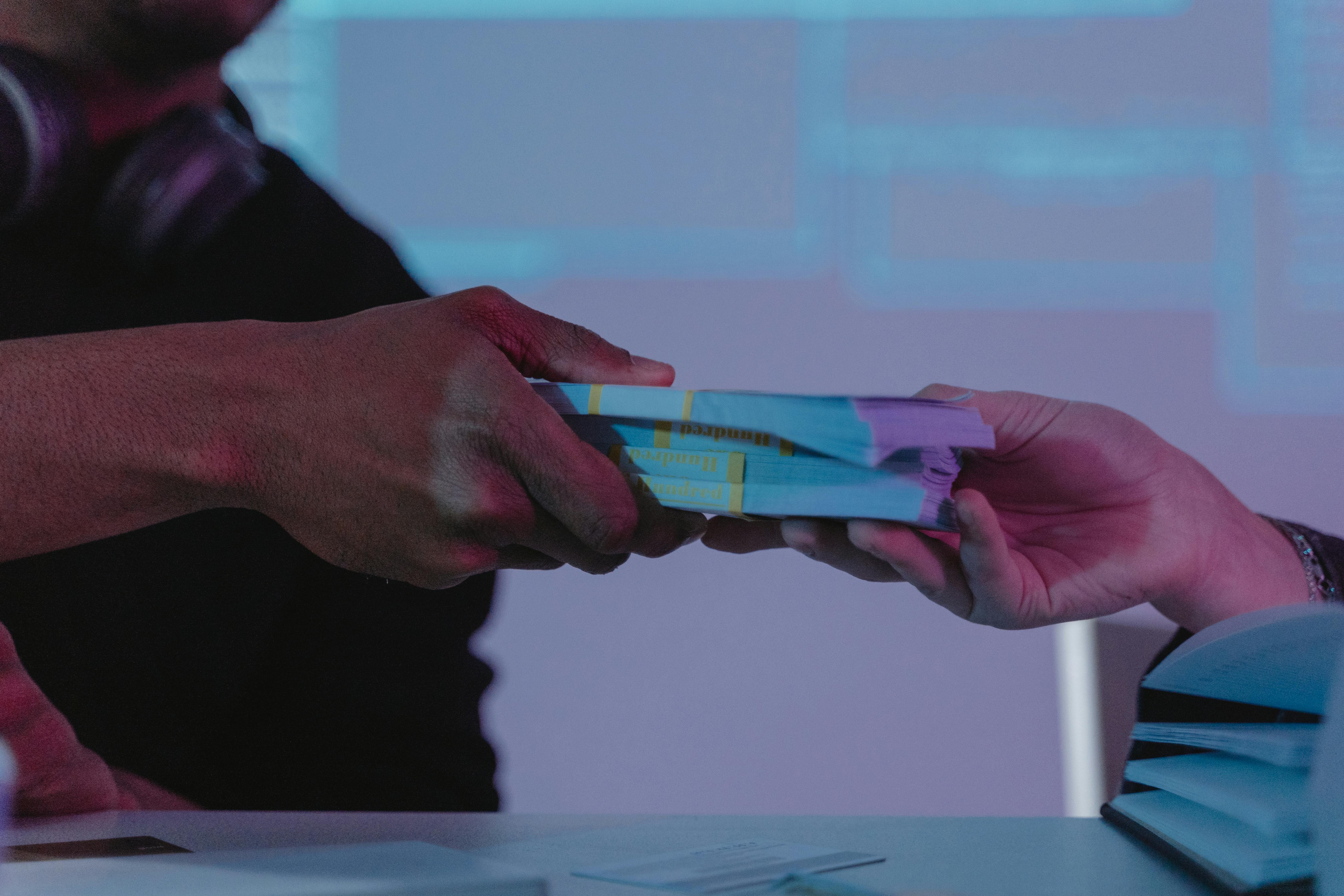 Handing over a stack of money